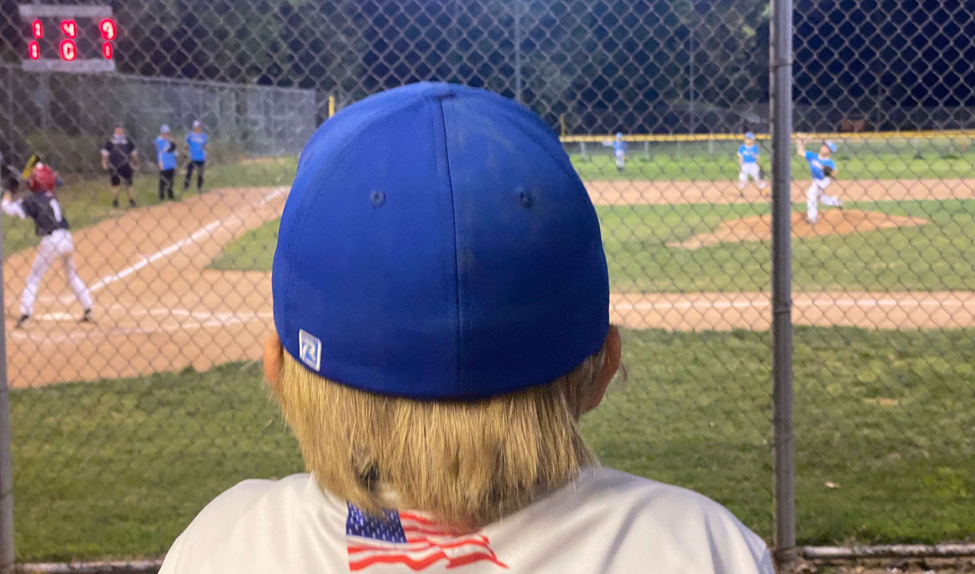 Kid watching a baseball game